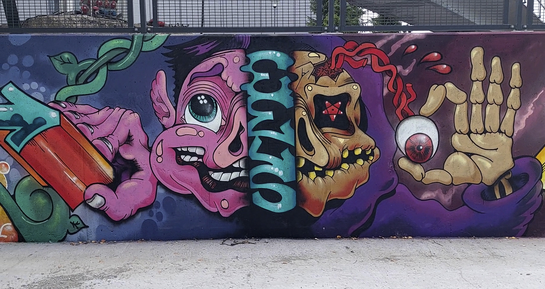 Graffititeos, jossa hahmo ja pääkallo.